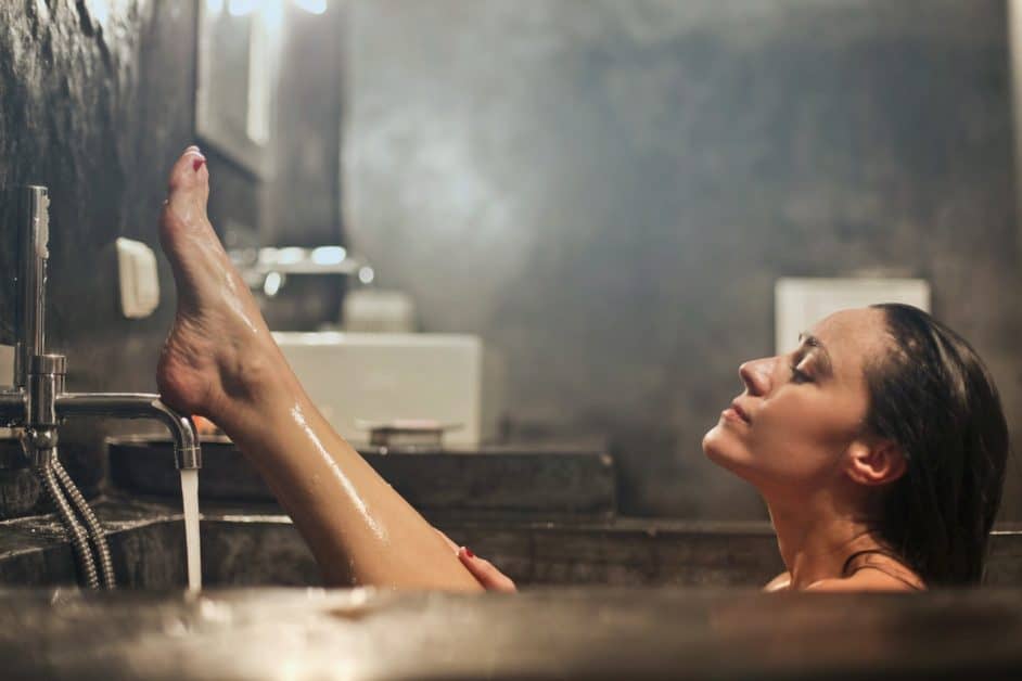 It's bath time! Relax in the tub and reap the benfits of lounging in hot water, just like this woman in her ultra-modern bathroom