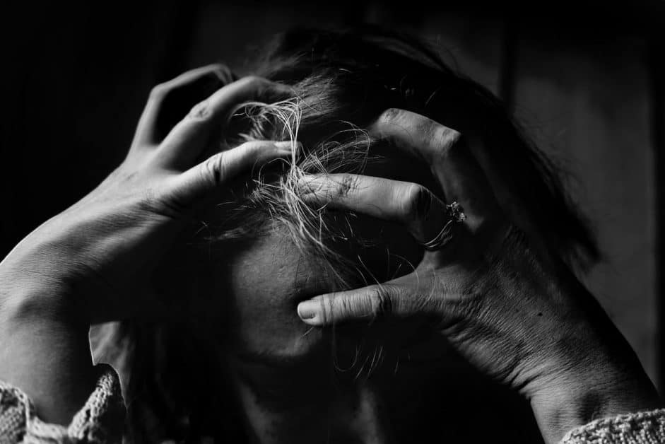 When you're stressed, staying healthy gets much harder, as this woman clutching her head with worry can attest.