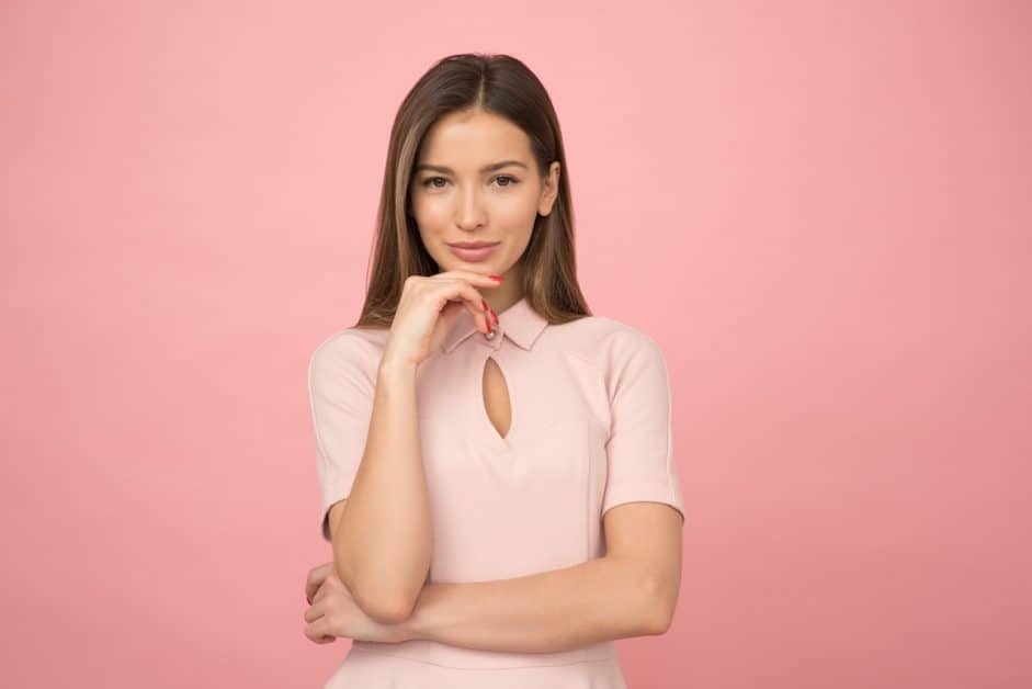 This super confident woman standing in front of a pink background really doesn't need to imrove her self-esteem - good for her!