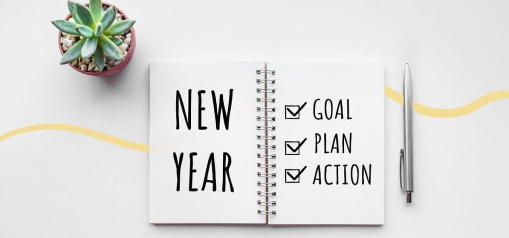 journal saying new year, goal, plan action