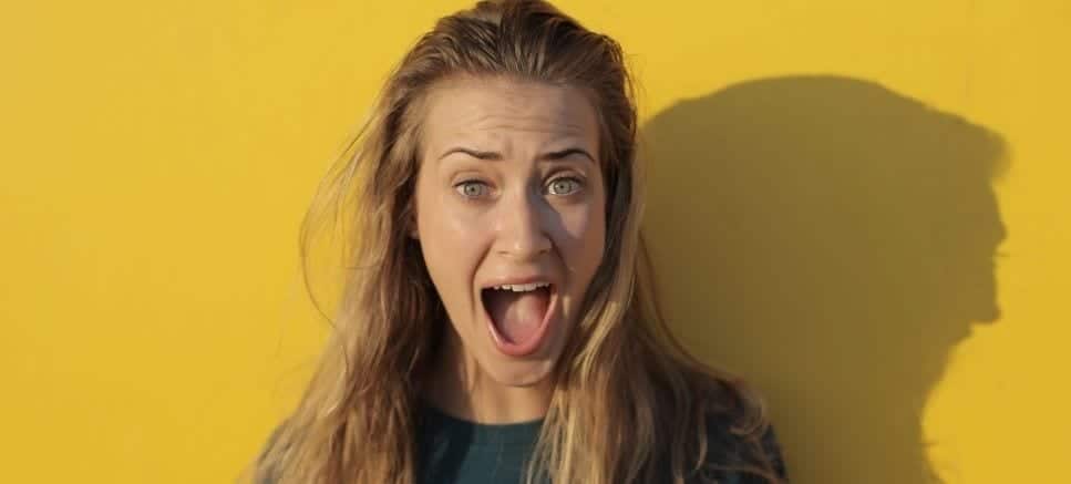 woman screaming on yellow background