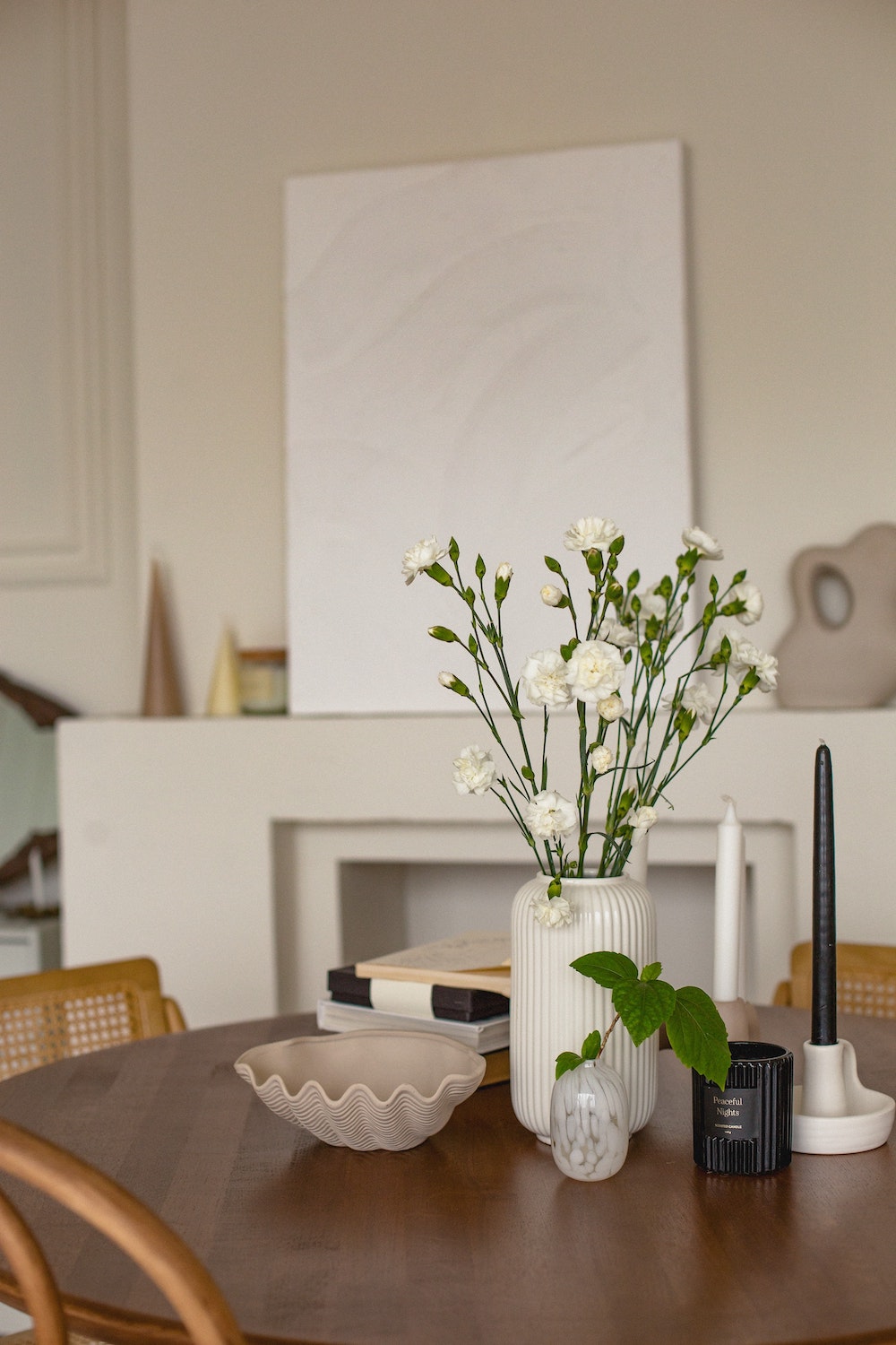 flowers on a table with a fireplace in the background