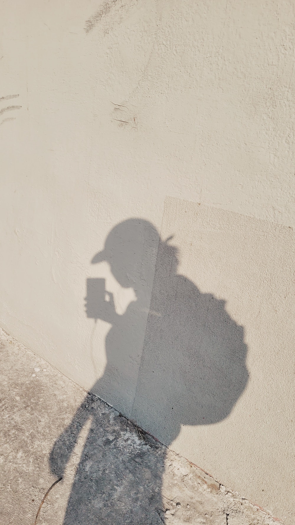 woman shadow on light wall