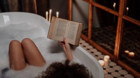 women reading book in a bath